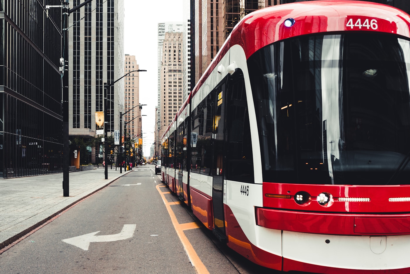 A red-and-white TTC streetcar on a downtown Toronto street